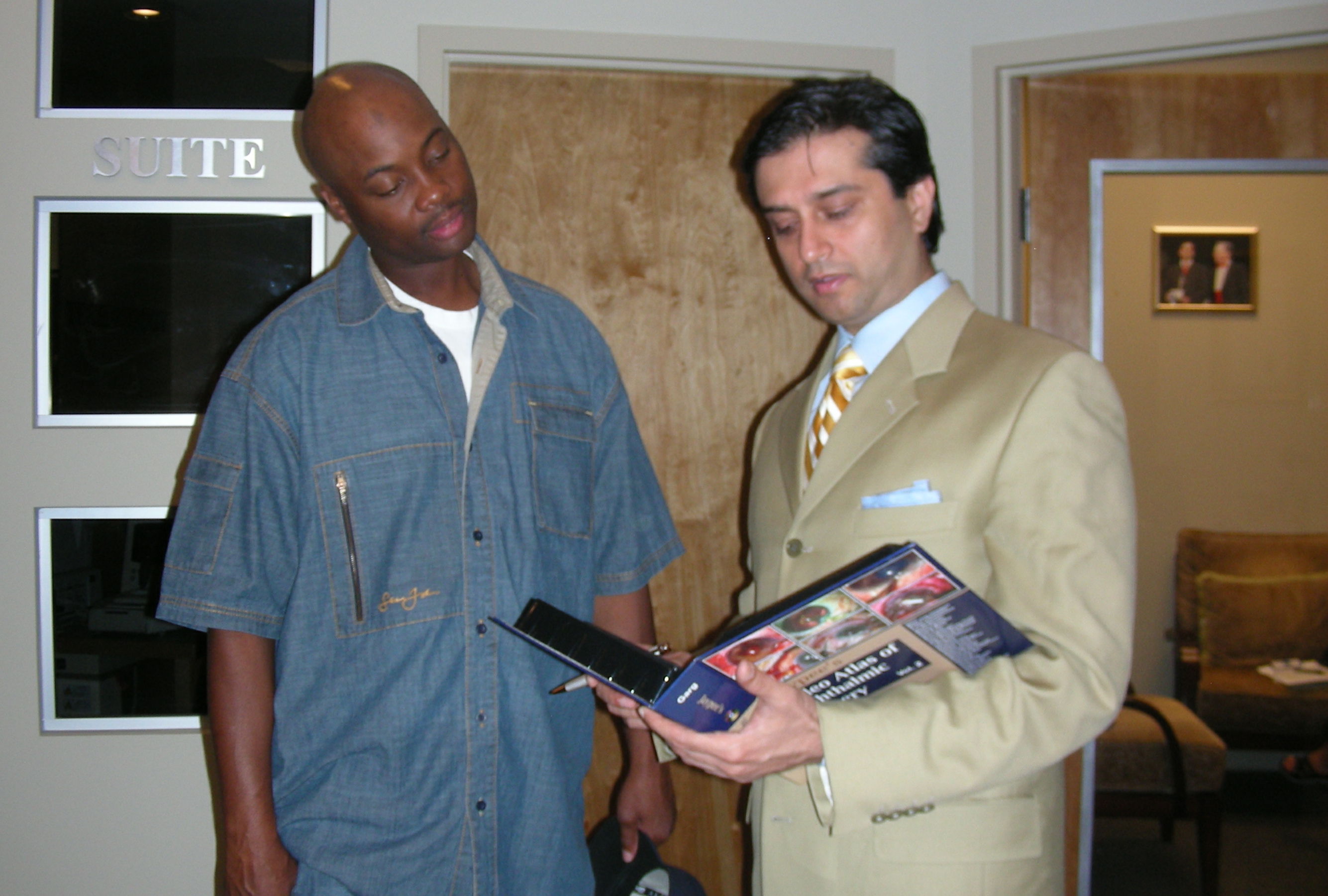 Dr. Gulani and Acie reviewing the book