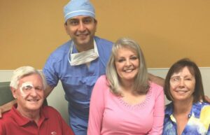 Dr. Gulani posing with Tony and Judy minutes after successful cataract surgery, all smiling with joy and clear vision.