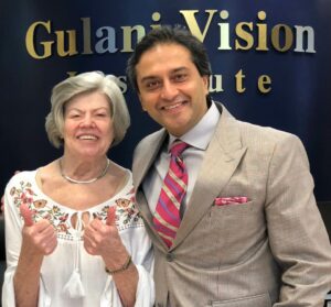 Dorothy T. with Dr. Gulani on Day 1 post-op, celebrating her vision breakthrough after being told nothing could be done.
