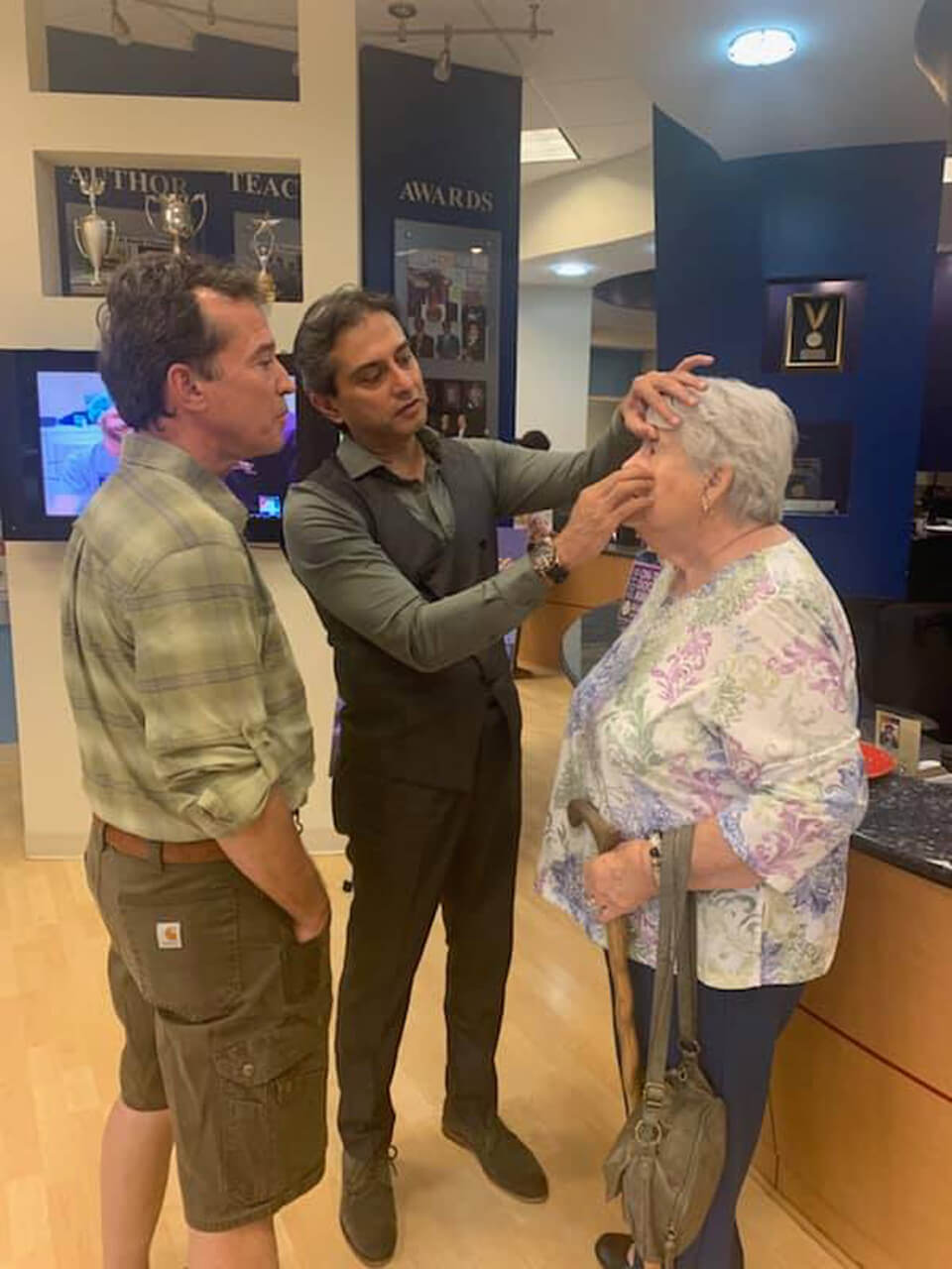 Dr. Gulani Looking into an Older Patients Eye