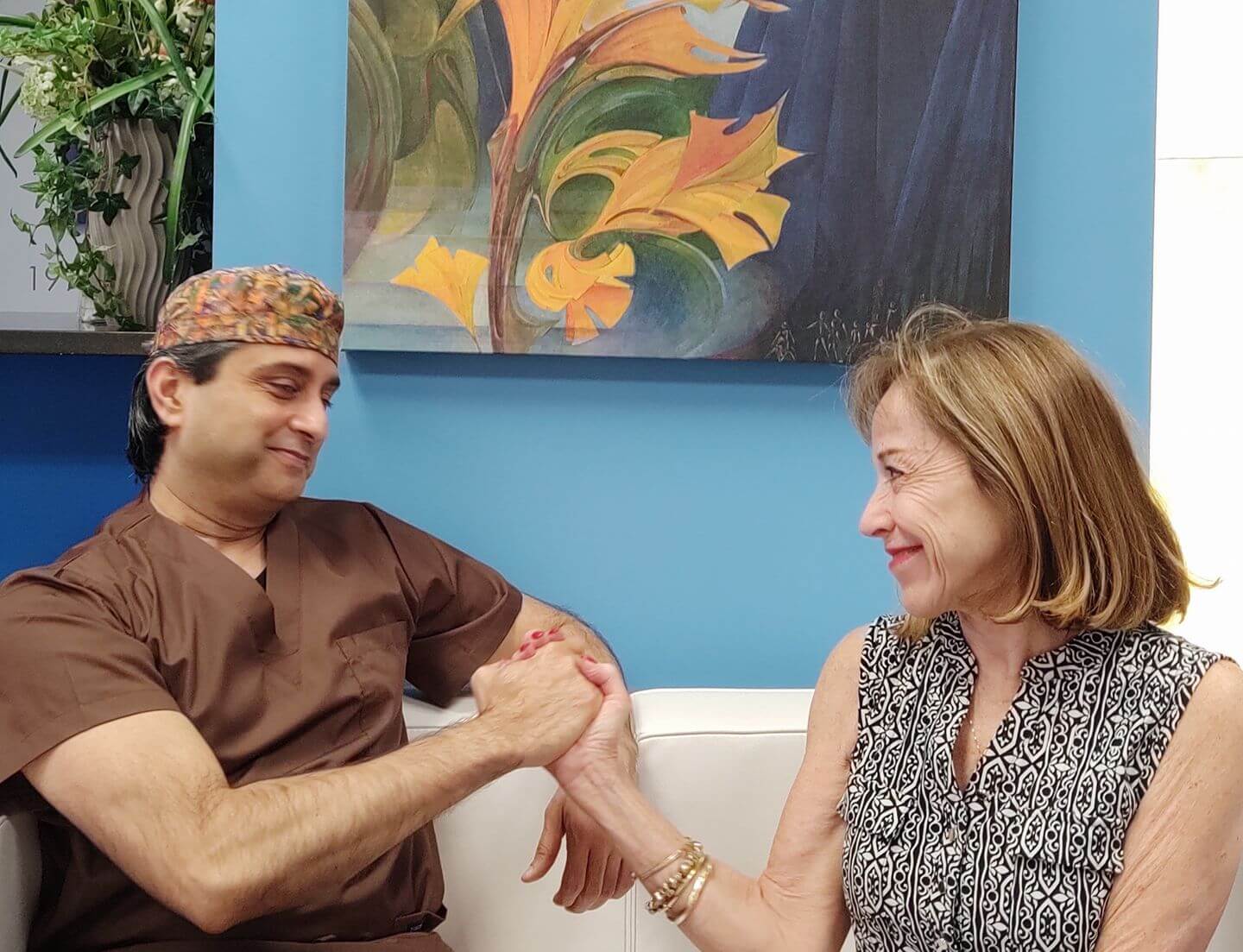 Dr. Gulani Holding a Patients Hand