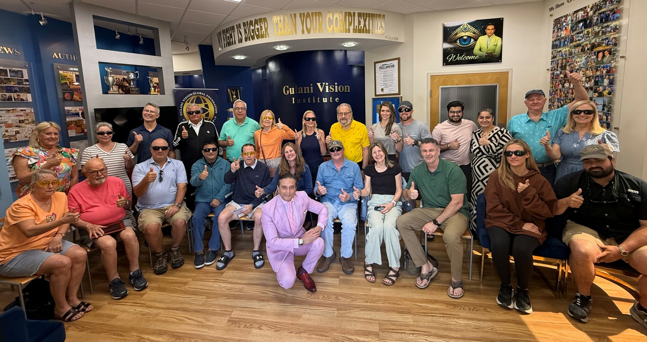 Group of international patients one day after LASIK, RK, and cataract complication correction surgery at Gulani Vision Institute in Jacksonville, smiling and showing restored vision before flying home