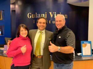 Dr. Arun C. Gulani with a smiling patient after successful ICL surgery at Gulani Vision Institute in Jacksonville, Florida.