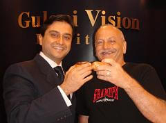 Dr. Gulani and Thomas Cheering With a Donut